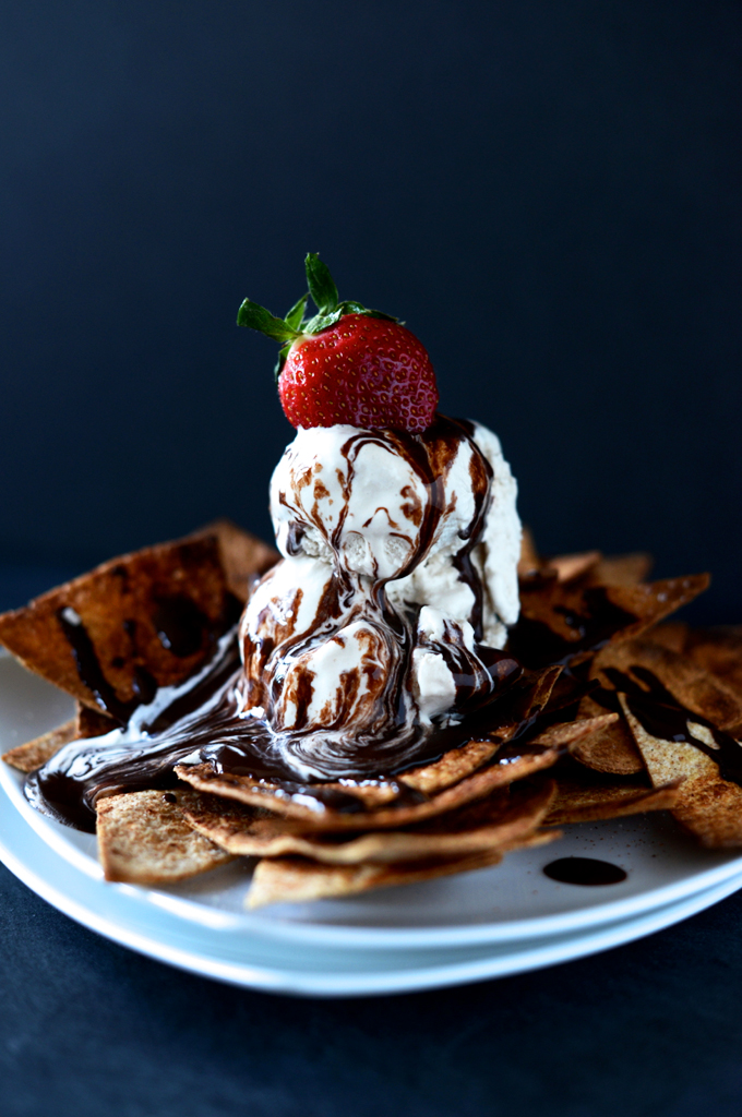 Plate of Vegan Dessert Nachos with ice cream, chocolate sauce, and a strawberry