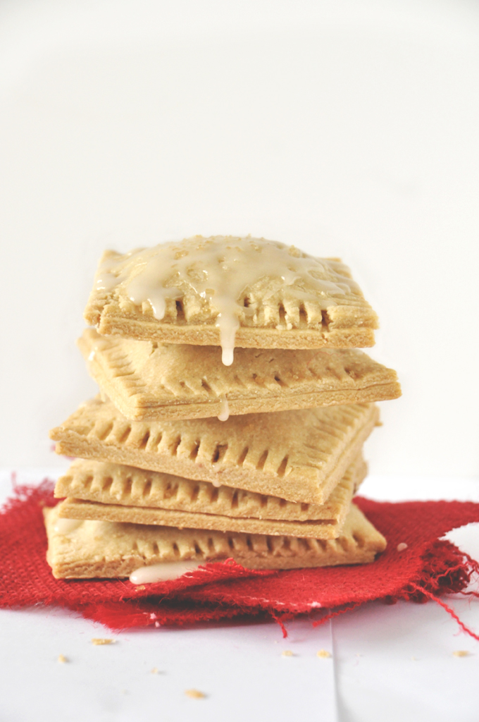 Stack of homemade Mixed Berry Pop Tarts with icing dripping down the side