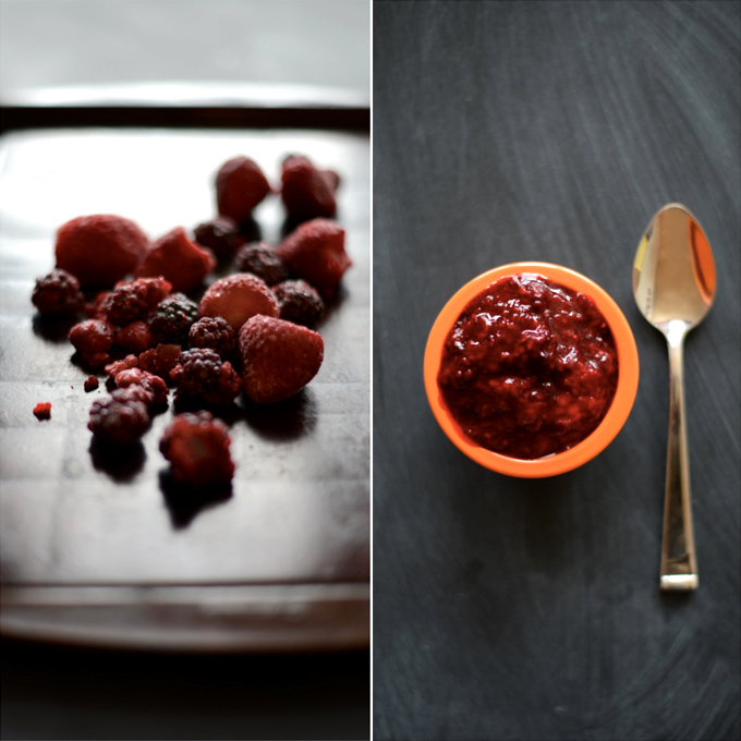 Baking sheet with mixed berries and bowl of homemade mixed berry compote