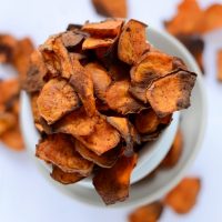 Overflowing tower of bowls filled with homemade Spicy Sweet Potato Chips