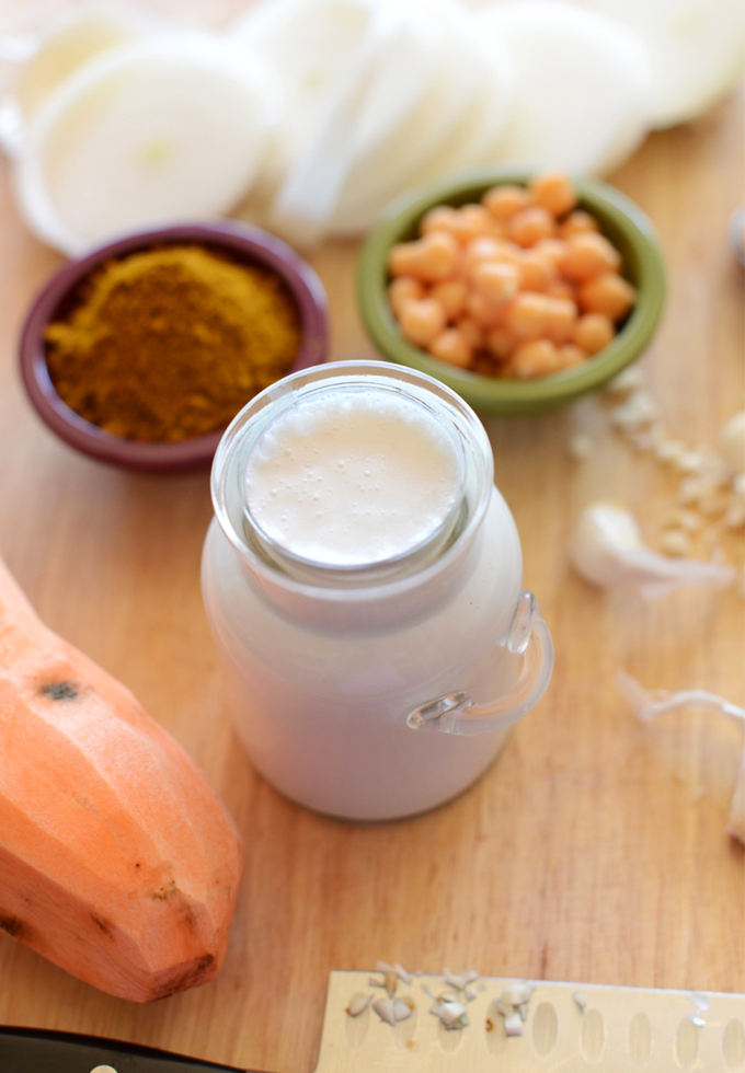 Jar of coconut milk and bowls of chickpeas and curry powder