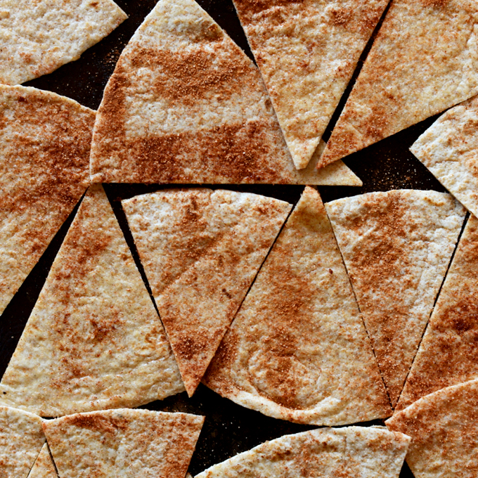 Baking sheet with tortilla strips coated in cinnamon and sugar