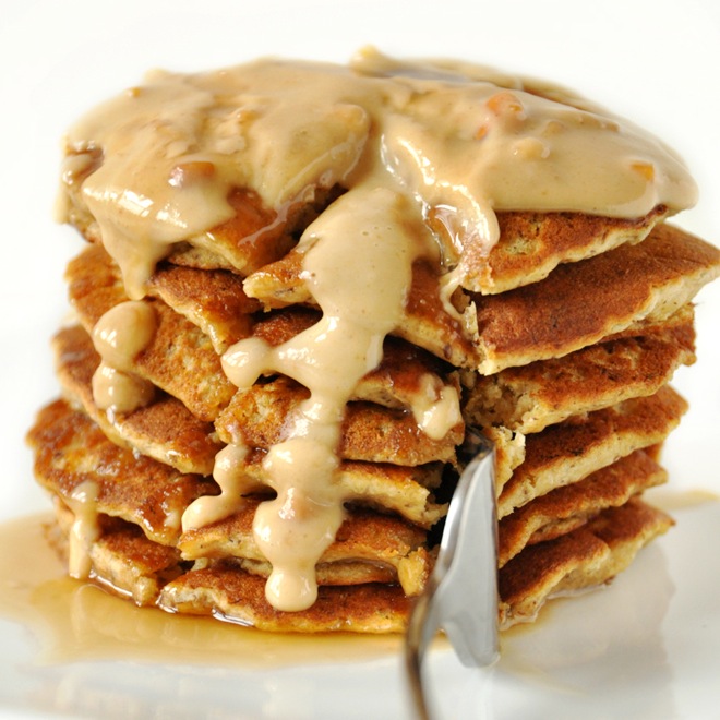 Using a fork to slice into a stack of Peanut Butter Flaxseed Pancakes
