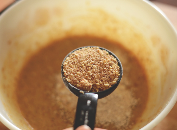 Measuring spoon filled with flaxseed meal for making Gluten-Free Vegan Breakfast Cookies