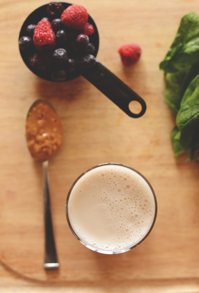 Berries, spinach, peanut butter and a glass of almond milk