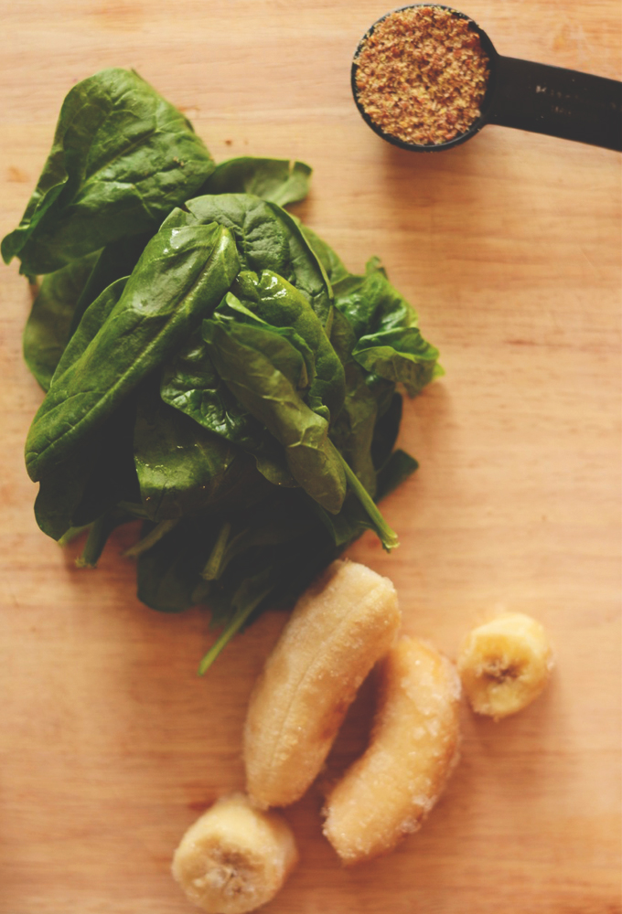 Cutting board with spinach, banana, and flax seed