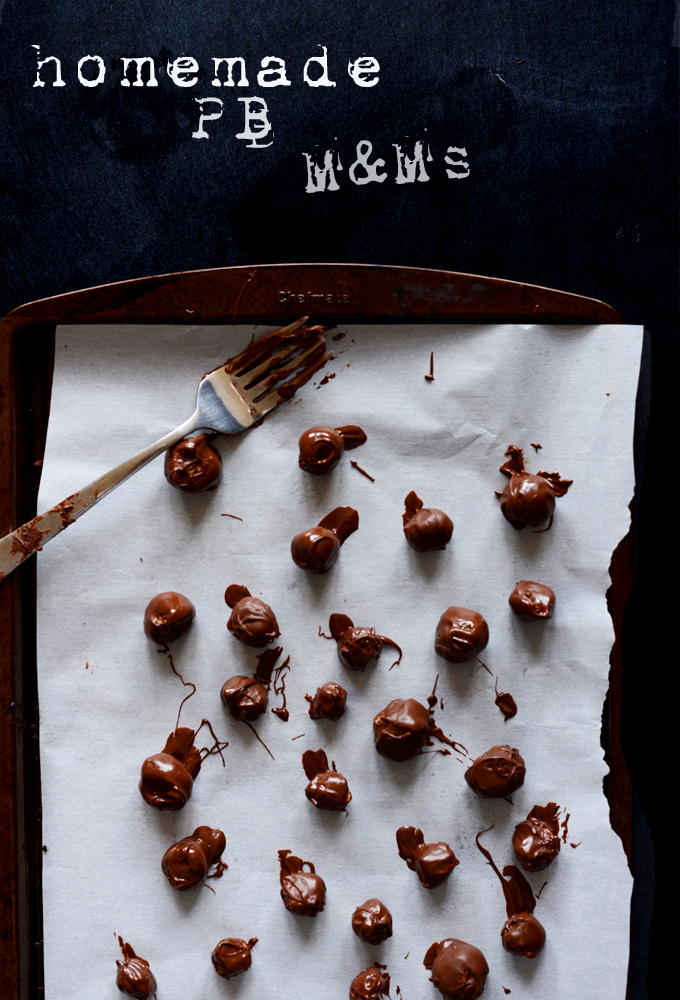 Parchment-lined baking sheet with a batch of our homemade Peanut Butter M&Ms