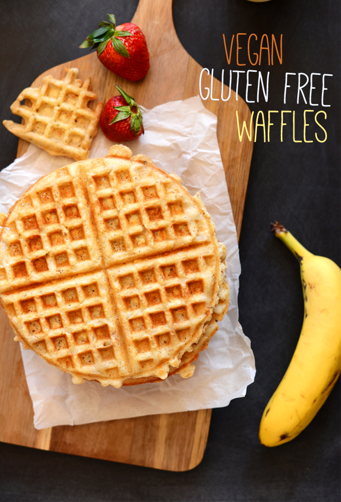 Homemade Vegan Gluten-Free Oatmeal Waffle on a cutting board alongside fresh fruit