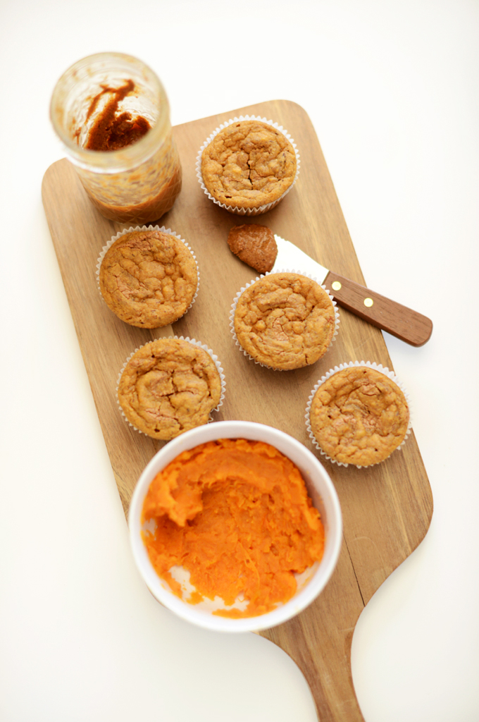 Cutting board with a batch of our Vegan Sweet Potato Almond Butter Muffins recipe