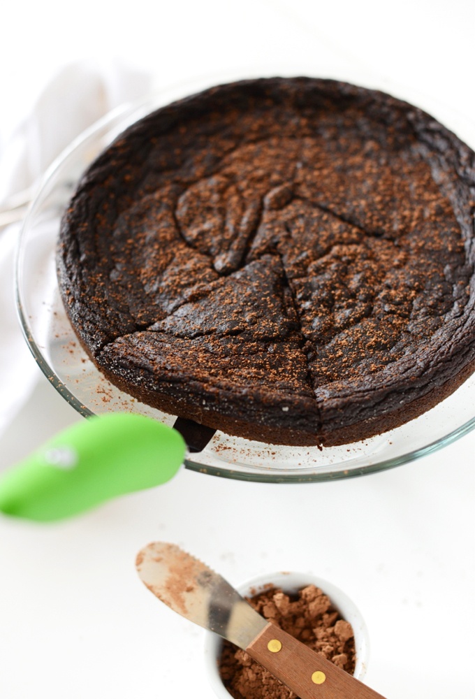 Grabbing a slice of gluten-free Chocolate Pie Cake from a platter