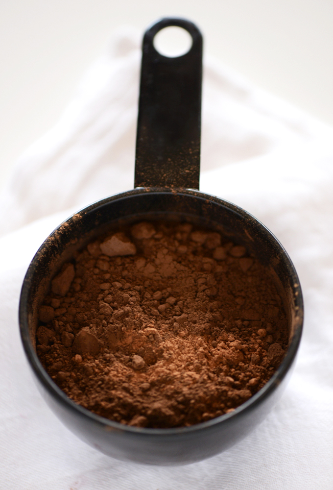 Measuring cup of cocoa powder