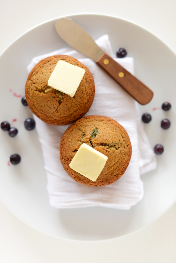 Two Gluten-Free Blueberry Muffins topped with vegan butter