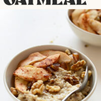 Spoon resting in a bowl of date-sweetened apple pie oatmeal with text that says vegan and gluten-free