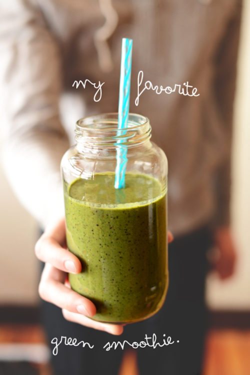 Holding a jar of our Green Smoothie recipe for a simple breakfast