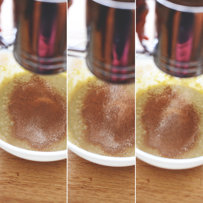 Sifting gluten-free flour into chocolate cake batter