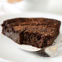 Slice of Fudgy Gluten-Free Chocolate Cake with a bite removed