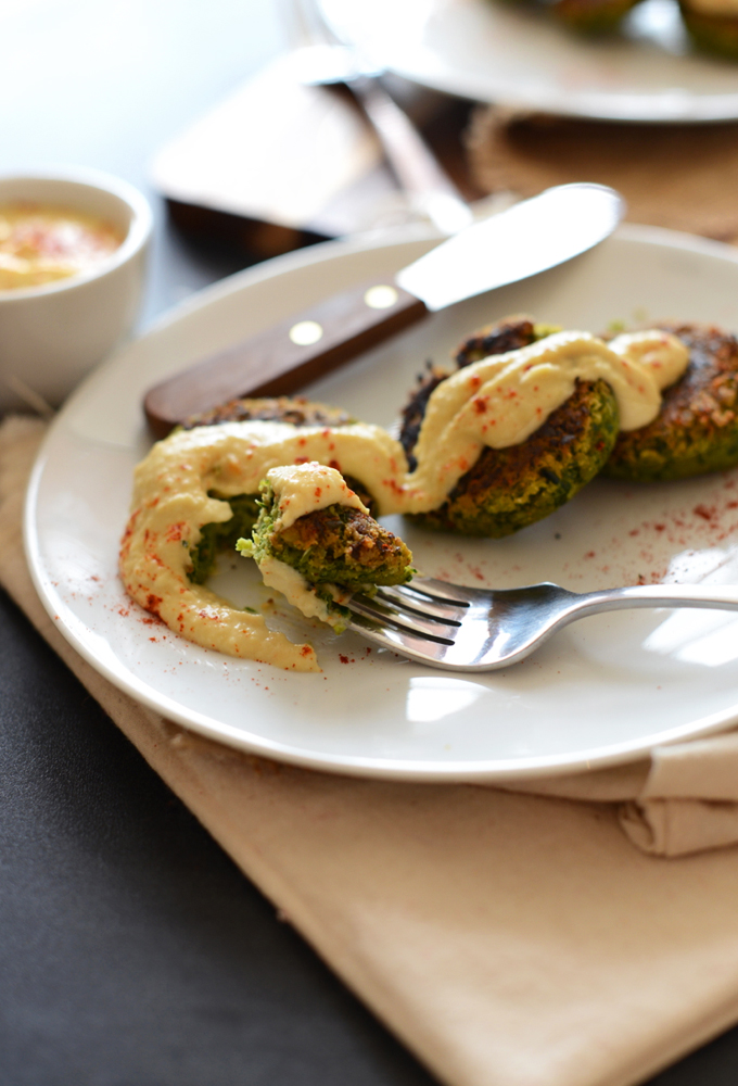 Grabbing a bite of Vegan Gluten-Free Falafel topped with hummus