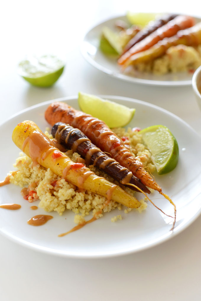 Plates of our Curry Roasted Carrots with Peanut Sauce for a gluten-free vegan side dish