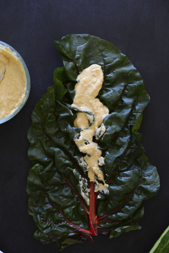 Hummus slathered on a rainbow chard leaf for making Hummus Wraps