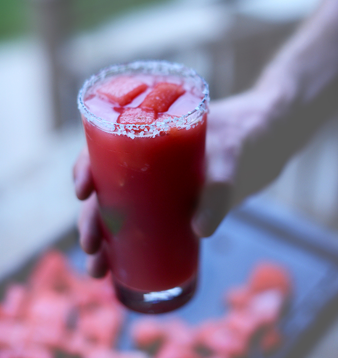 Tall glass of our Lime Watermelon Margarita recipe with chunks of melon in it