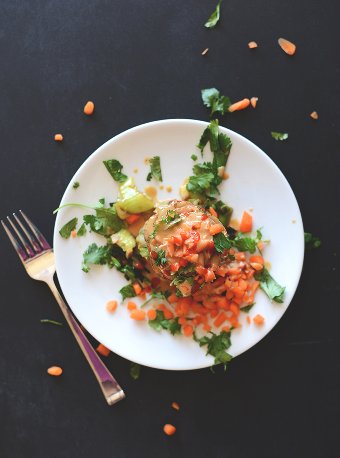 Plate of Sweet Potato Stacks topped with peanut sauce, sriracha, and cilantro