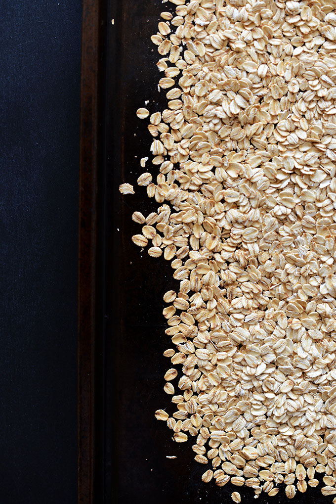 Toasting rolled oats on a baking sheet