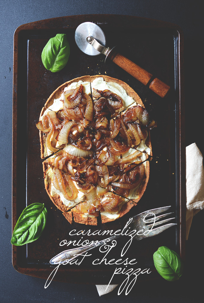 Baking sheet with Caramelized Onion and Goat Cheese Pizza cut into slices