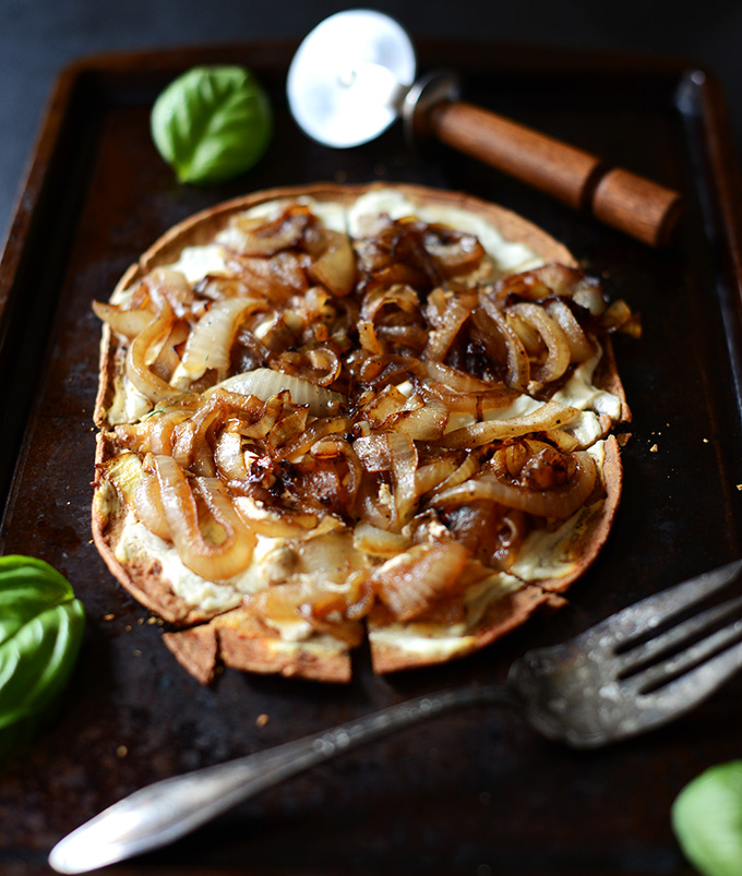 Freshly sliced Goat Cheese Caramelized Onion Flatbread on a baking sheet