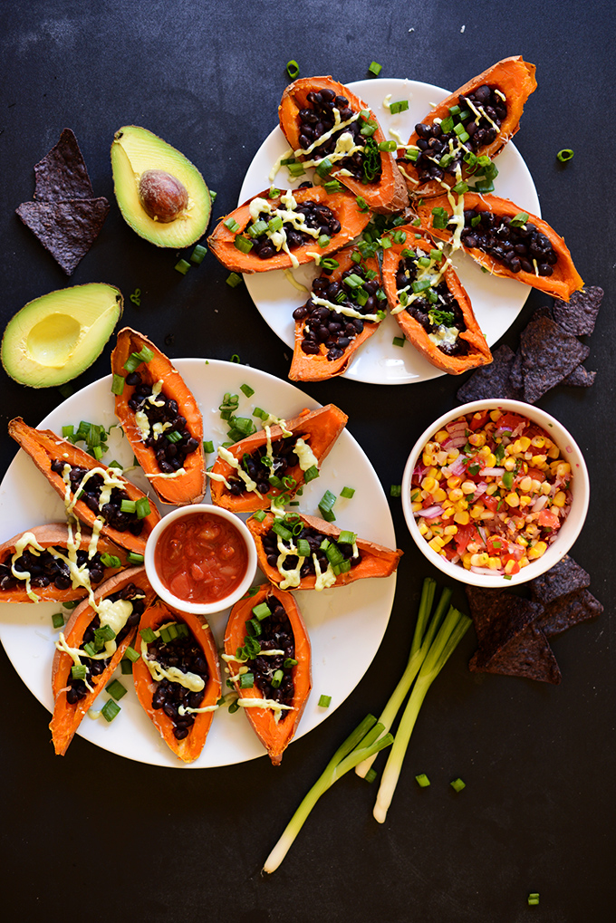 Plates of colorful Loaded Sweet Potato Boats for a delicious vegan meal