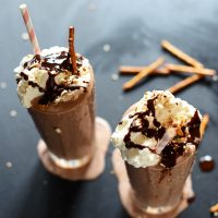 Overflowing glasses of Pretzel Frozen Hot Chocolate