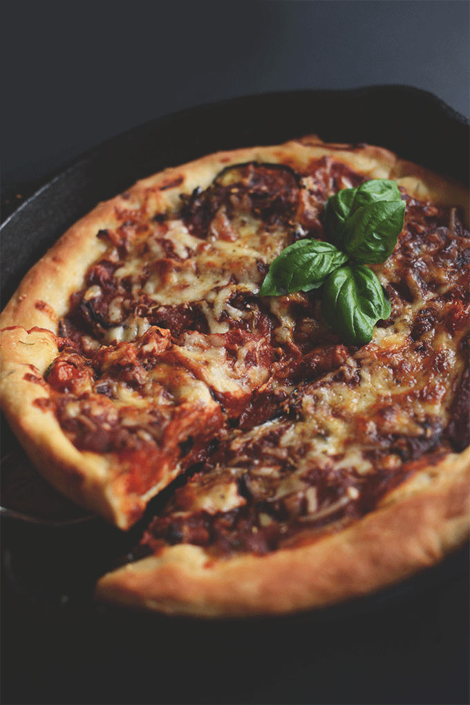 Grabbing a slice of Deep Dish Pizza from a skillet