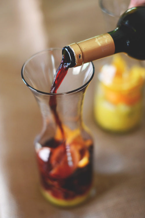 Pouring wine into a jug to make our Spanish Sangria recipe