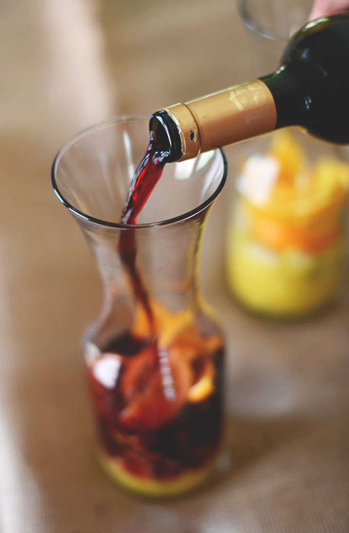 Pouring red wine into a jug for our homemade Sangria recipe