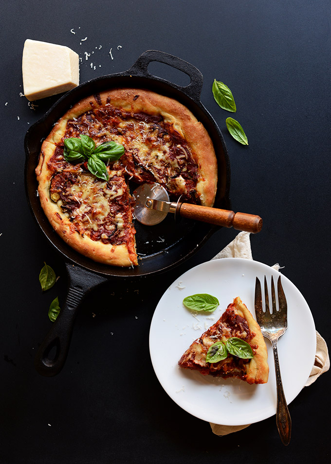 Slice of Deep Dish Roasted Veggie Pizza removed from the rest of the skillet