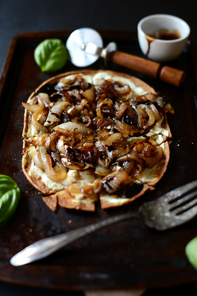 Homemade Goat Cheese Caramelized Onion Pizza on a baking sheet