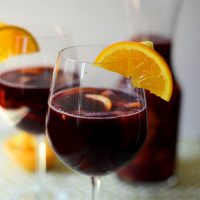 Wine glasses of Spanish Sangria with orange slices on the rims