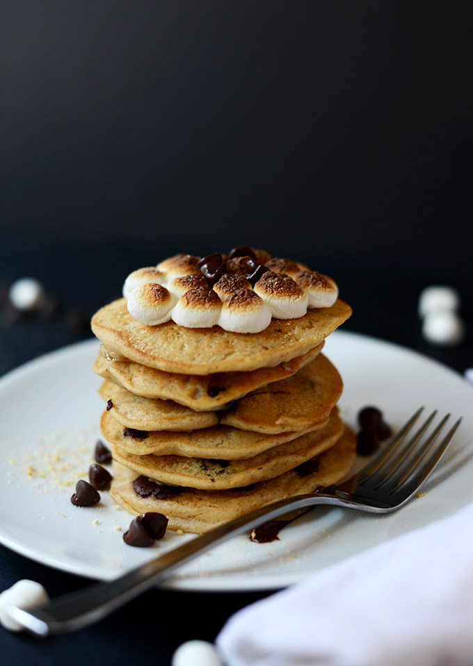 Stack of vegan pancakes with toasted marshmallows and melted chocolate on top