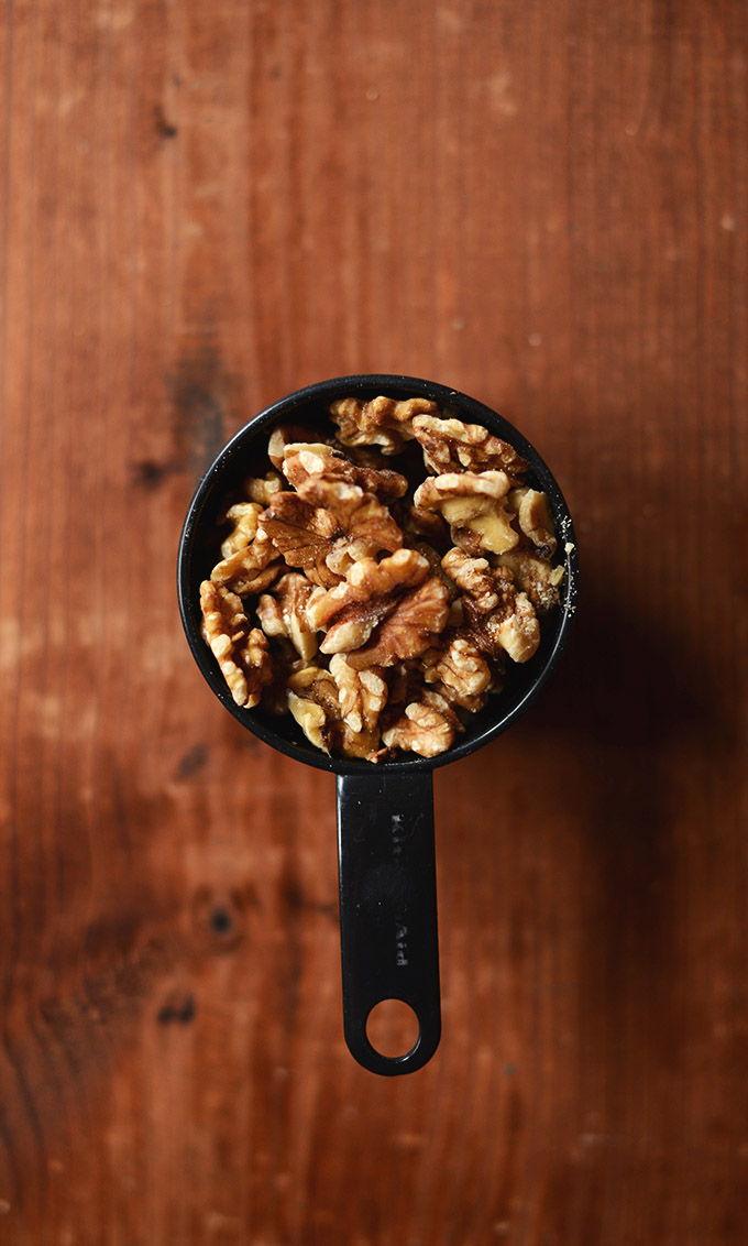 Measuring cup filled with walnuts for making Vegan Snickers Bars
