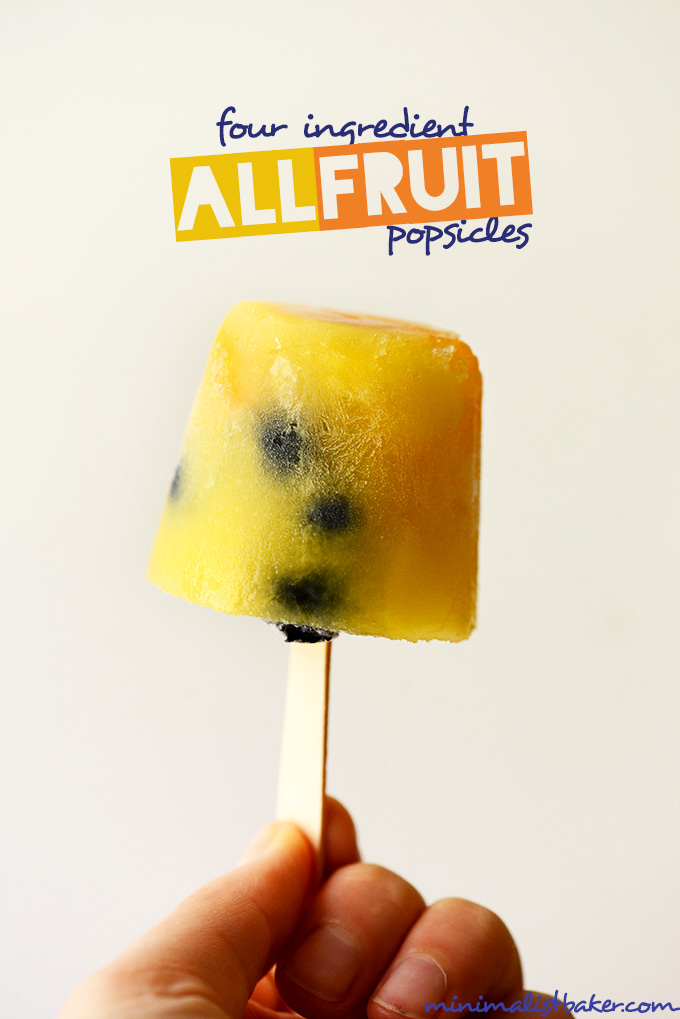 Holding up a homemade popsicle made only with fruit