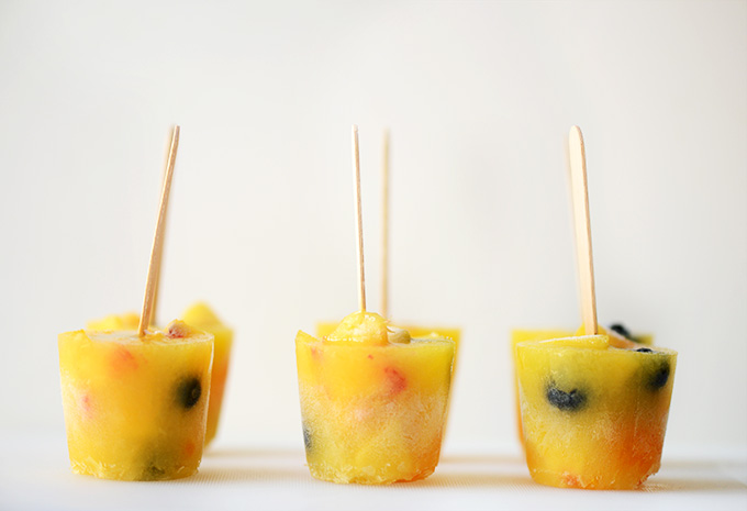 Side view of a batch of our homemade fruit popsicles