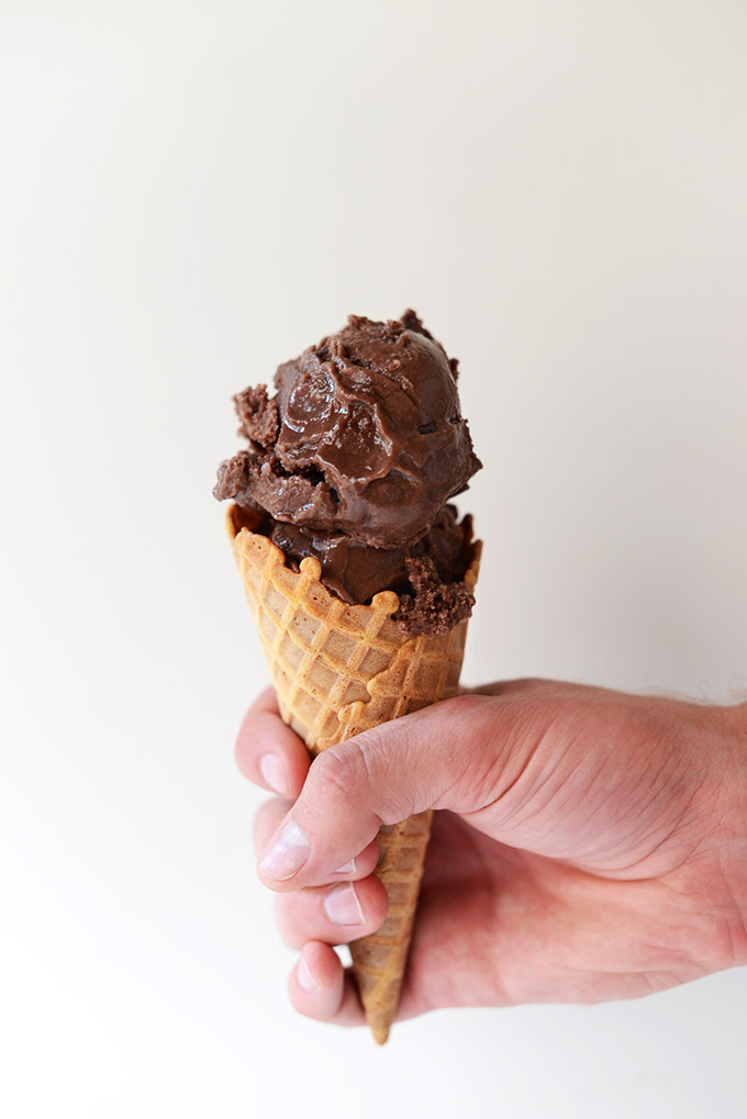 Holding a cone filled with Dairy-Free Chocolate Ice Cream