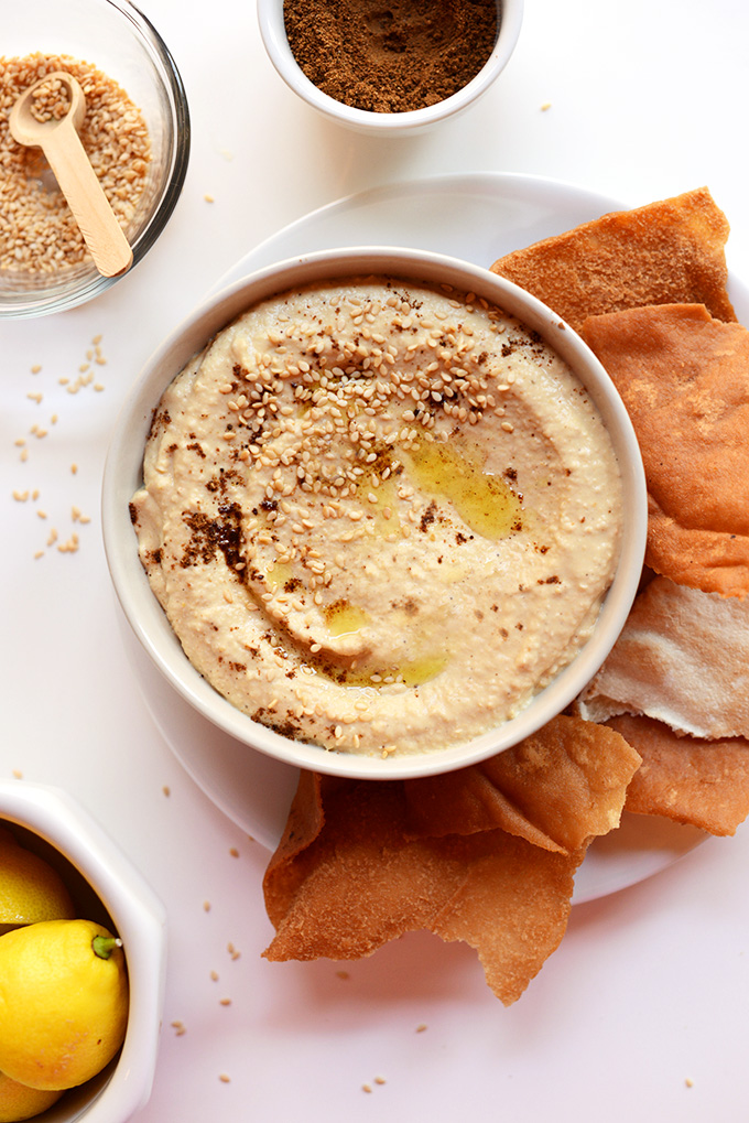 Pita chips, sesame seeds, garam masala, and a bowl of homemade hummus