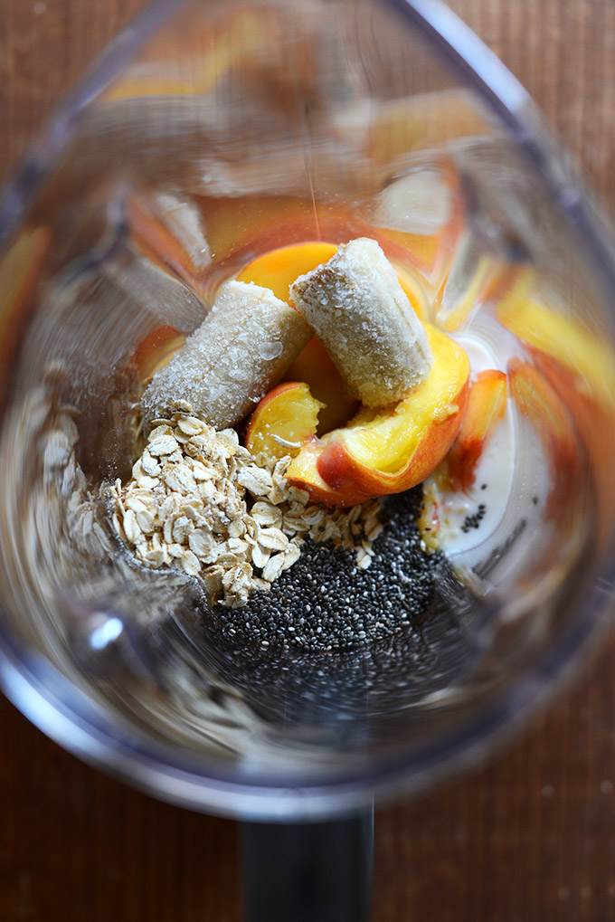 Blender with ingredients for making our Peach Oat Chia Smoothie recipe