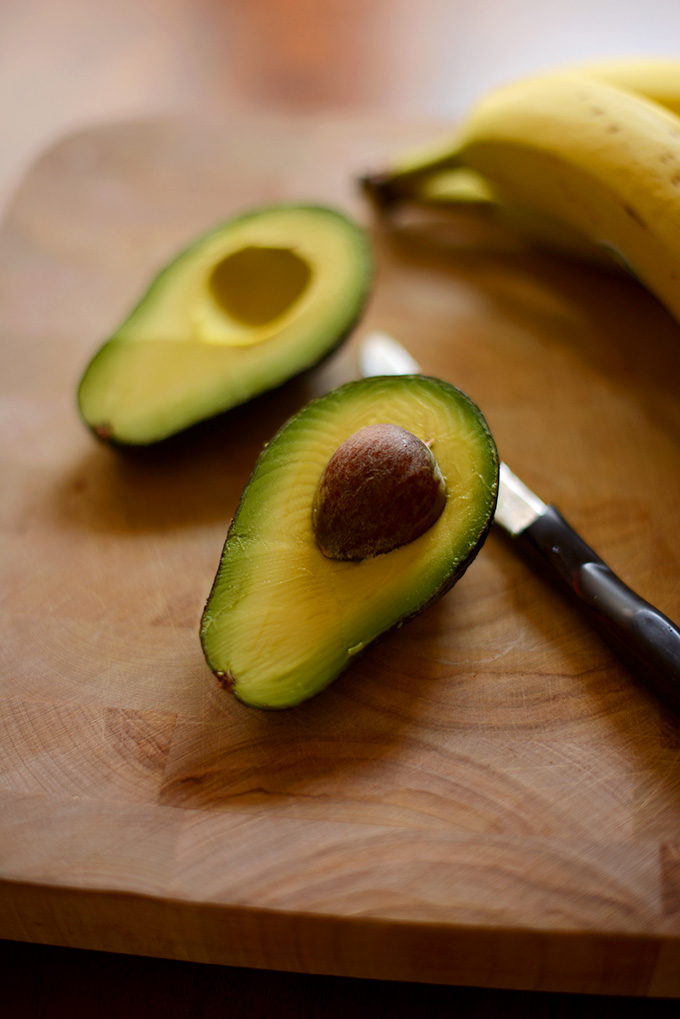 Halved avocado ready to be made into a Chocolate Avocado Milkshake