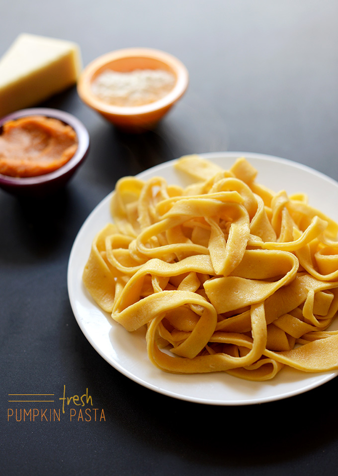 Plate of Fresh Homemade Pasta alongside small bowls of pumpkin, flour, and parmesan