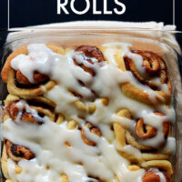 Pan of easy vegan cinnamon rolls with powdered sugar glaze on top