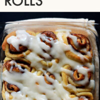 Pan of easy vegan cinnamon rolls with powdered sugar glaze on top