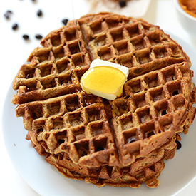 Stack of Vegan Pumpkin Spice Latte Waffles topped with vegan butter and maple syrup