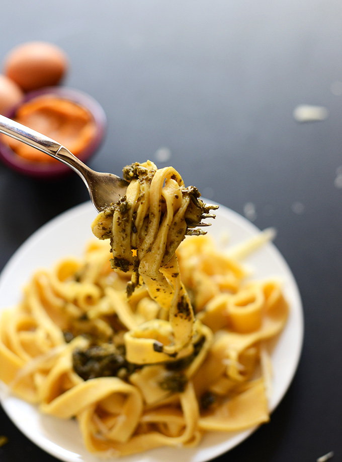Picking up a bite of Pumpkin Pasta with Pesto and Parmesan
