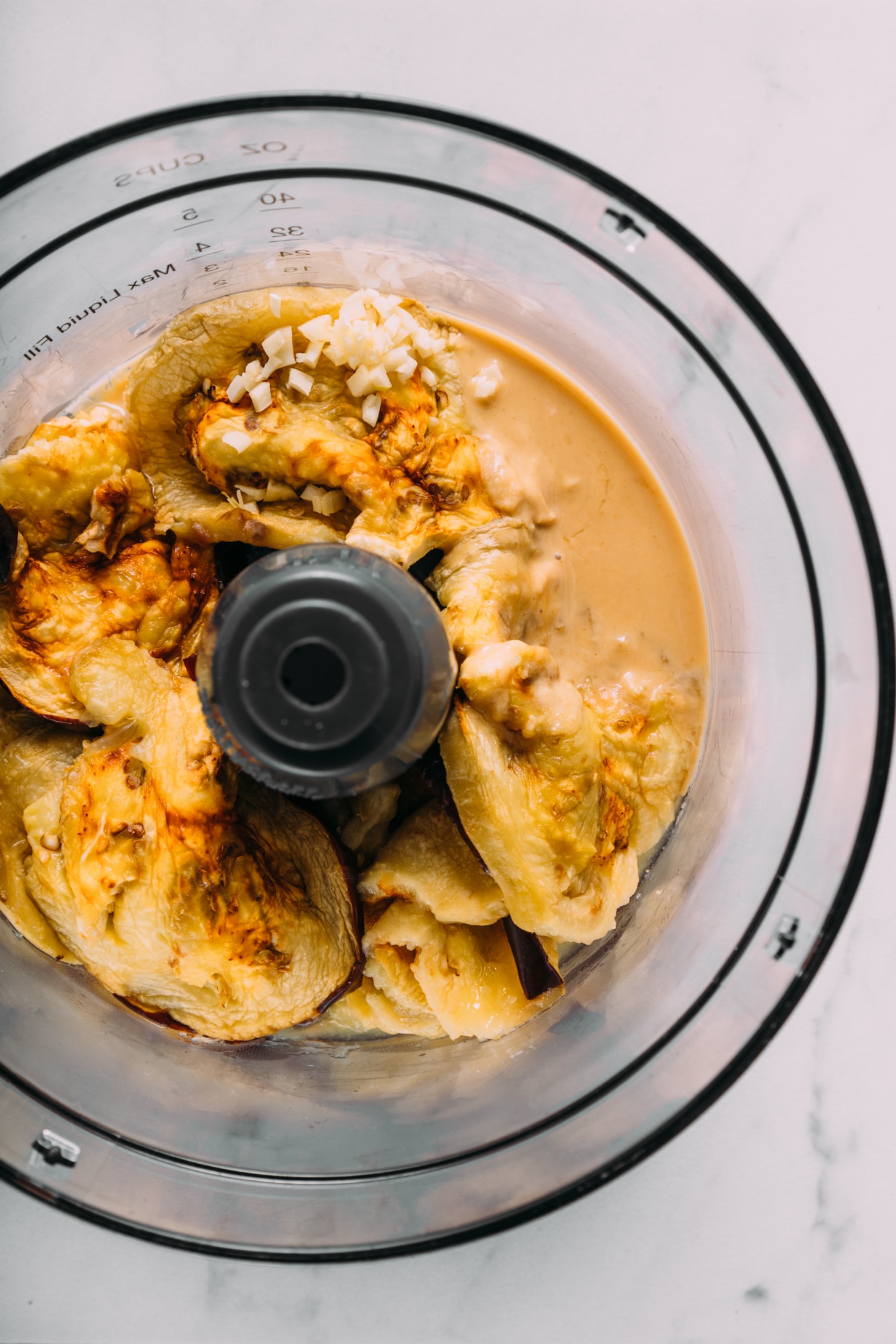 Food processor with ingredients for making our easy baba ganoush recipe